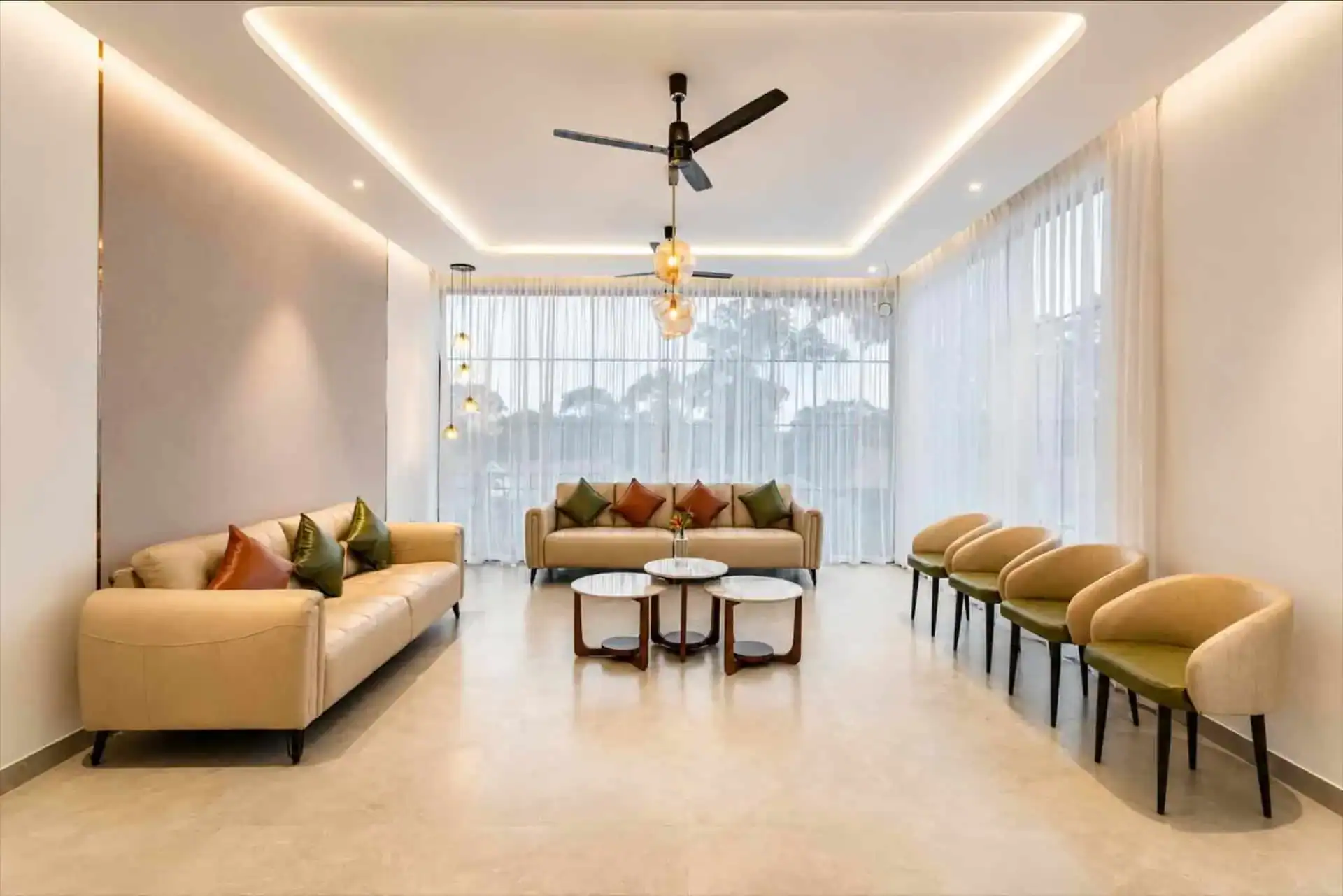 Elegant lobby lounge with cream sofas and sheer curtains at Vega Munnar Resorts