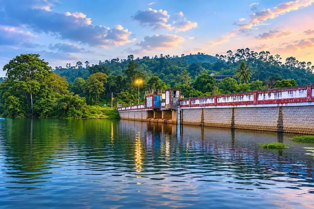 Sengulam Dam reservoir surrounded by tea estates and forested hills near Munnar