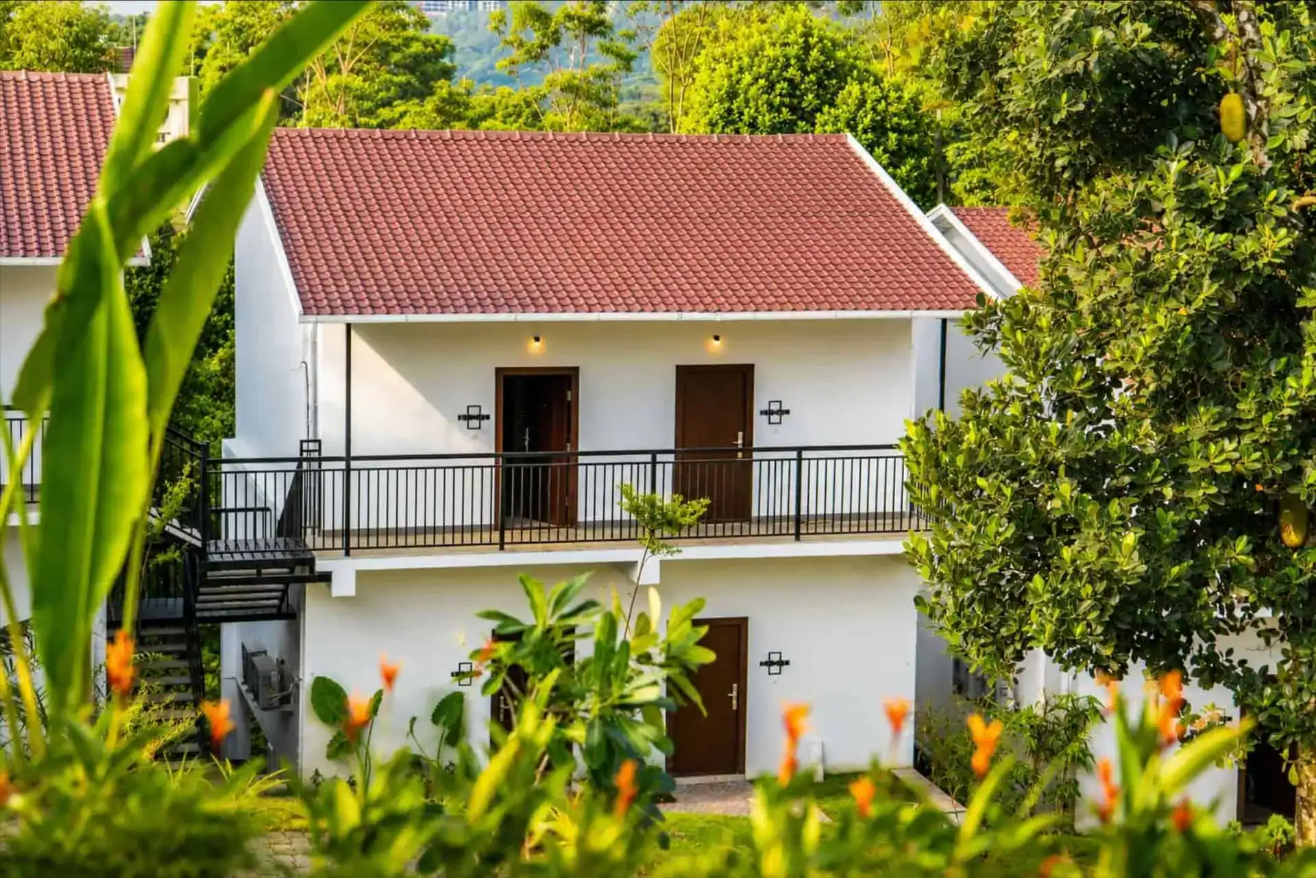 Vega Munnar cottage exterior with heliconia garden and lantern lighting