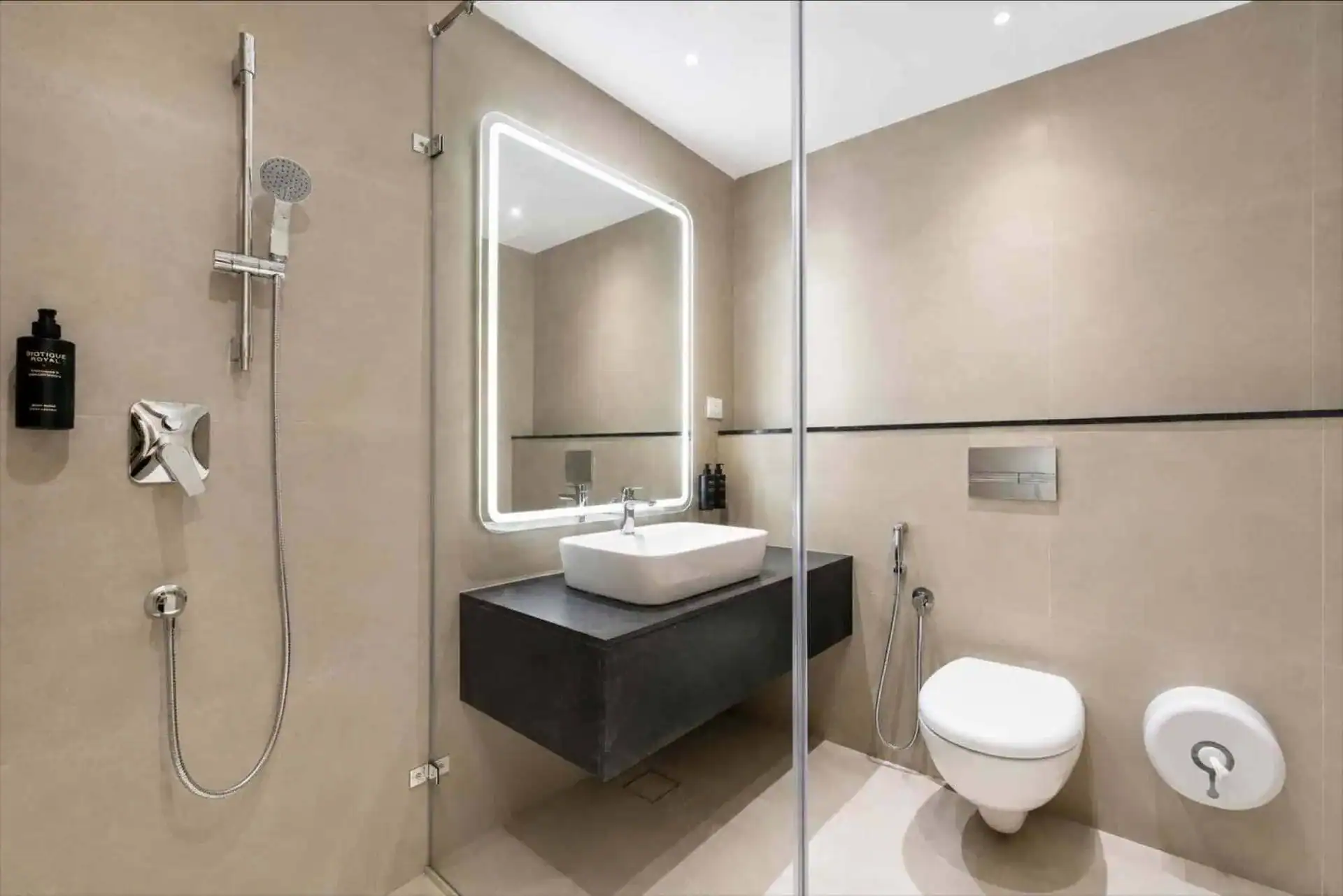 Contemporary en-suite with glass shower and backlit LED mirror