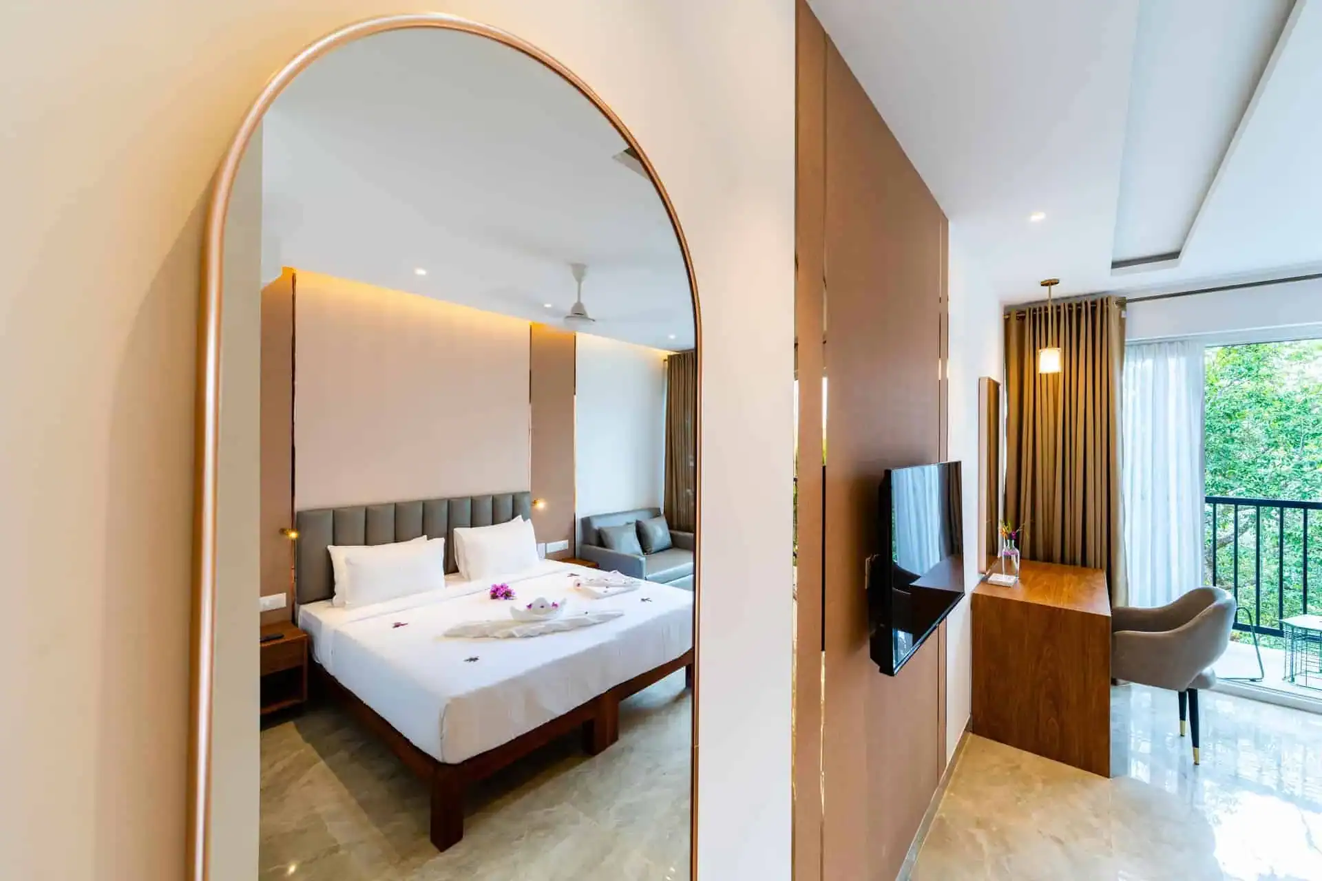 Vega Bliss Cottage with arched gold mirror reflecting the king bed