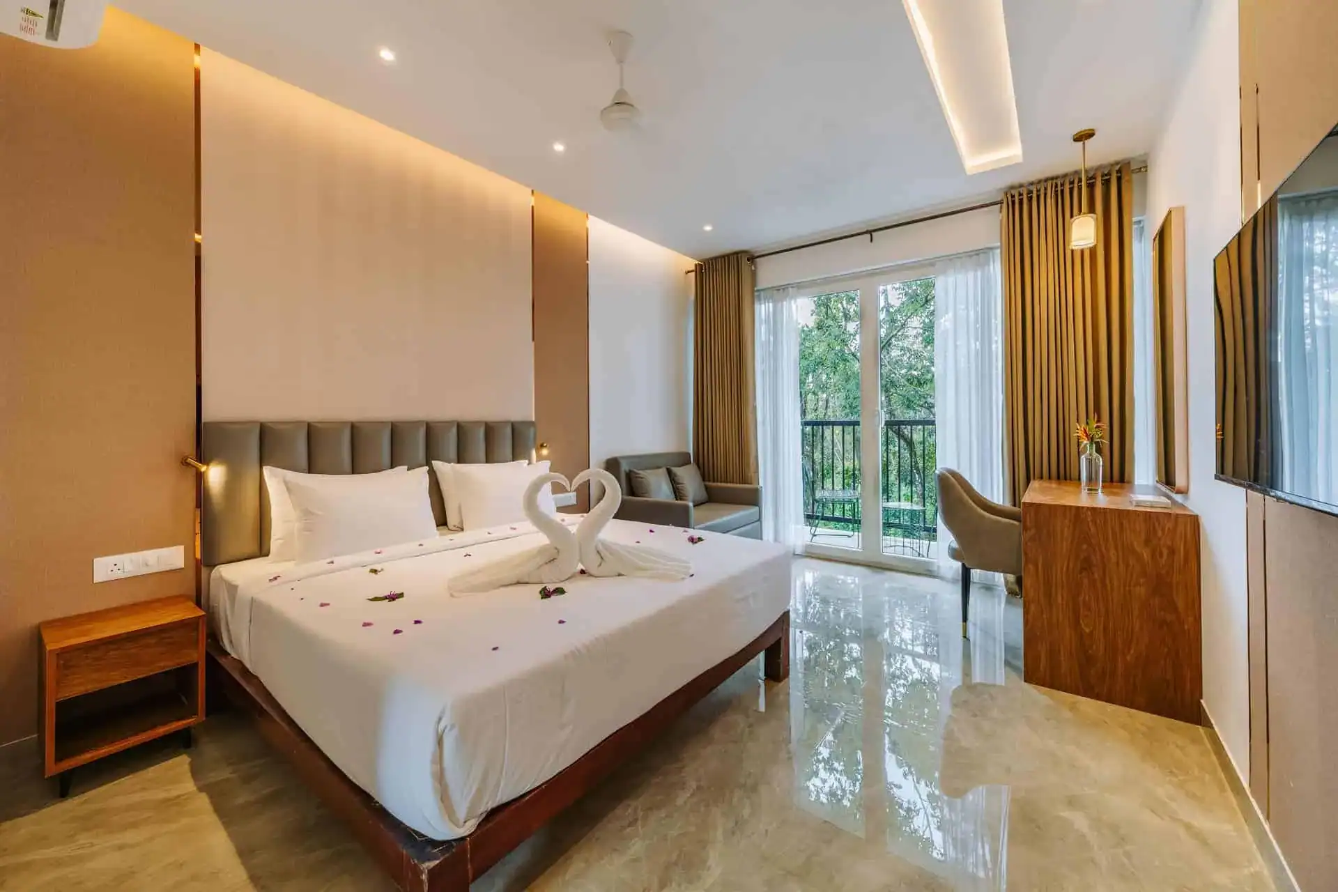 Vega Bliss Cottage honeymoon setup with rose petal decoration and king bed at Vega Munnar Resorts