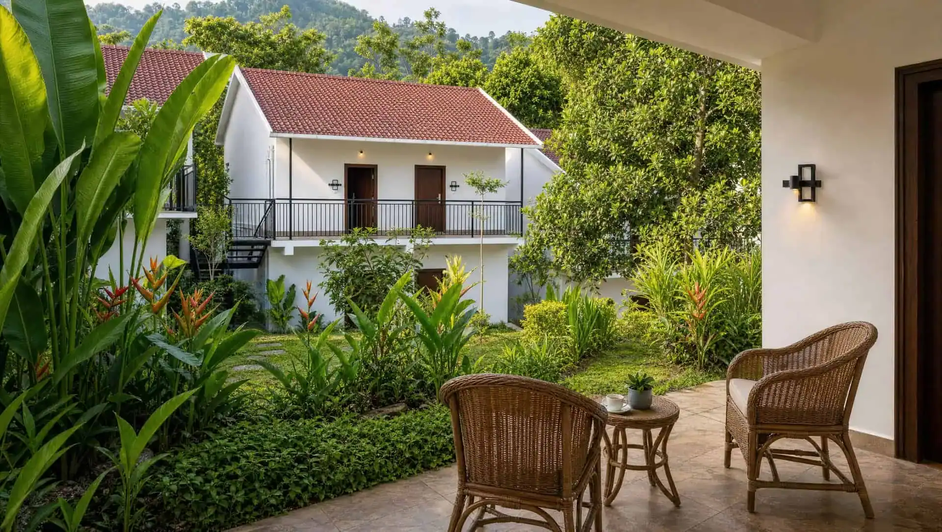 Vega Delight Cottage private garden patio with tropical plants at Vega Munnar